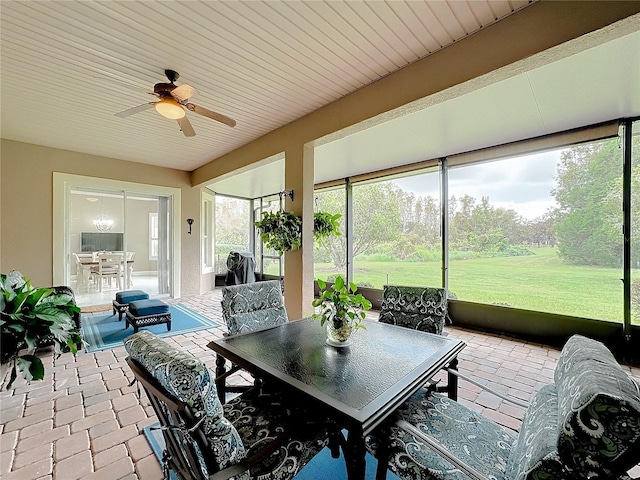 sunroom / solarium featuring ceiling fan