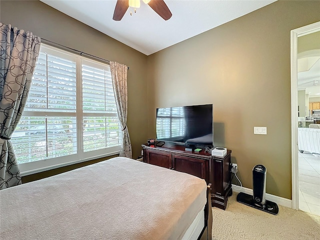 bedroom with ceiling fan and light carpet