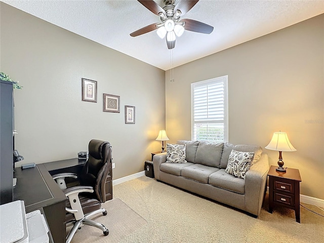 office space with a textured ceiling, carpet floors, and ceiling fan