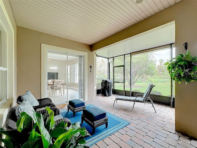 sunroom with an inviting chandelier