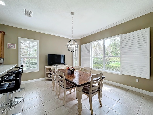 tiled dining area featuring crown molding, a textured ceiling, and a wealth of natural light