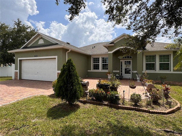 ranch-style house with a front yard and a garage