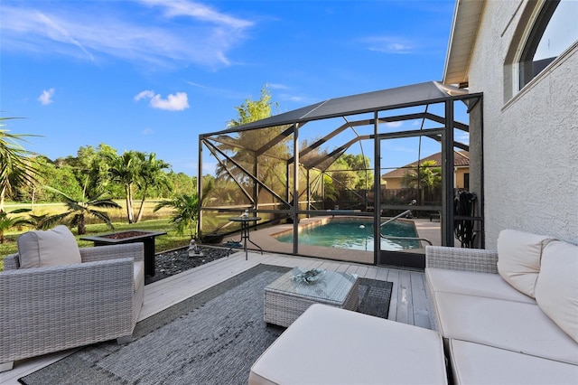 view of patio / terrace featuring outdoor lounge area and glass enclosure