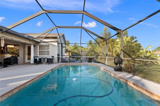 view of swimming pool featuring a patio and glass enclosure