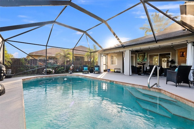 view of pool featuring ceiling fan, a lanai, and a patio