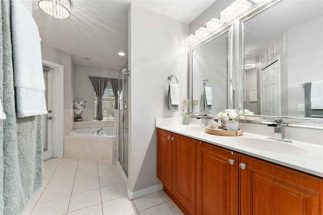 bathroom featuring tile patterned floors, vanity, and shower with separate bathtub