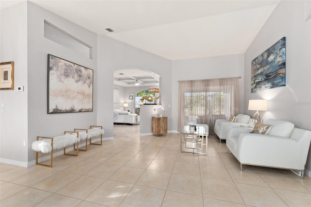 tiled living room with ceiling fan and coffered ceiling