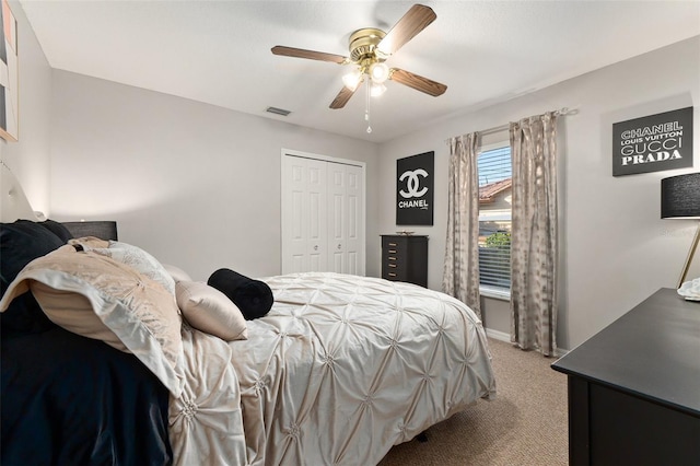 carpeted bedroom featuring ceiling fan and a closet