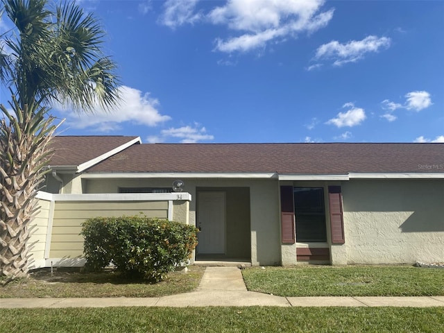 34 Pine Island Cir, Kissimmee, FL 34743 - view of front of house with stucco siding and roof with shingles