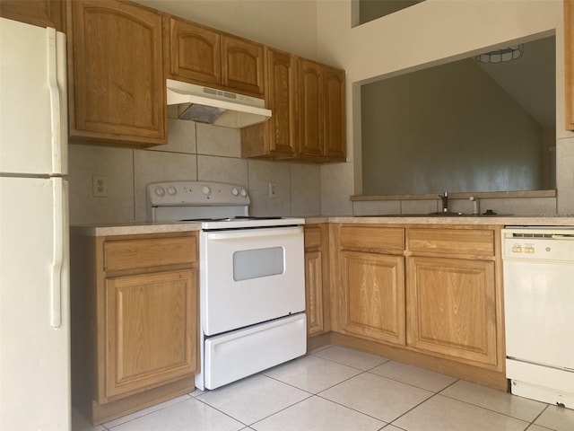34 Pine Island Cir, Kissimmee, FL 34743 - kitchen featuring white appliances, under cabinet range hood, light countertops, and light tile patterned floors