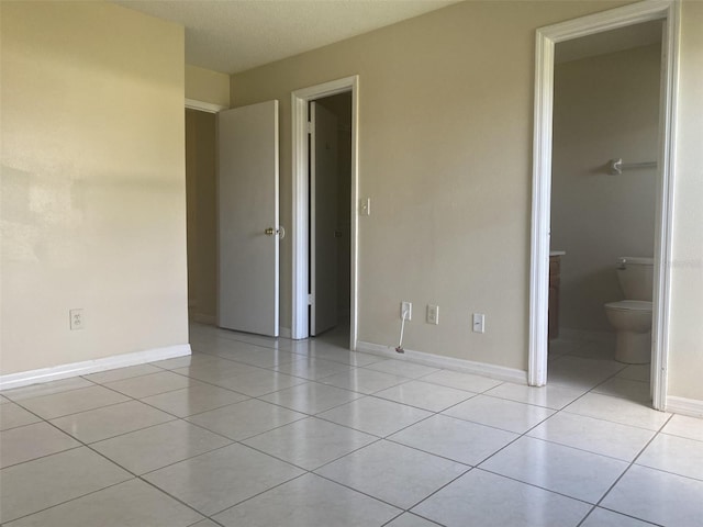 34 Pine Island Cir, Kissimmee, FL 34743 - unfurnished bedroom featuring light tile patterned flooring and ensuite bath