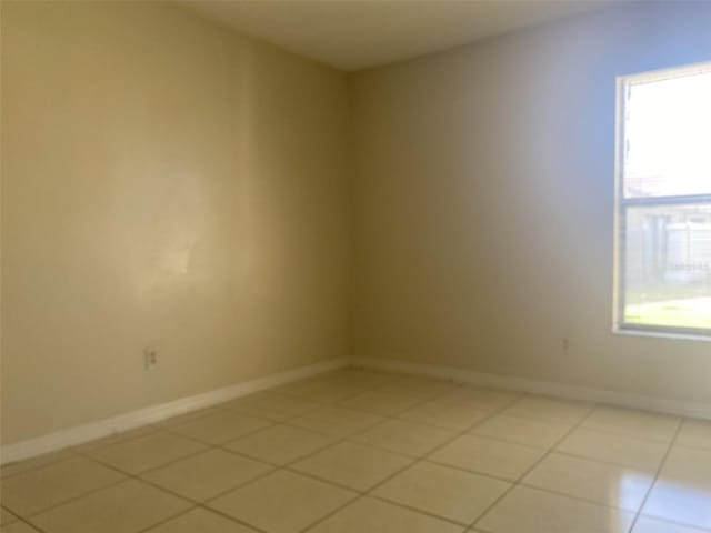 34 Pine Island Cir, Kissimmee, FL 34743 - spare room featuring light tile patterned flooring and baseboards