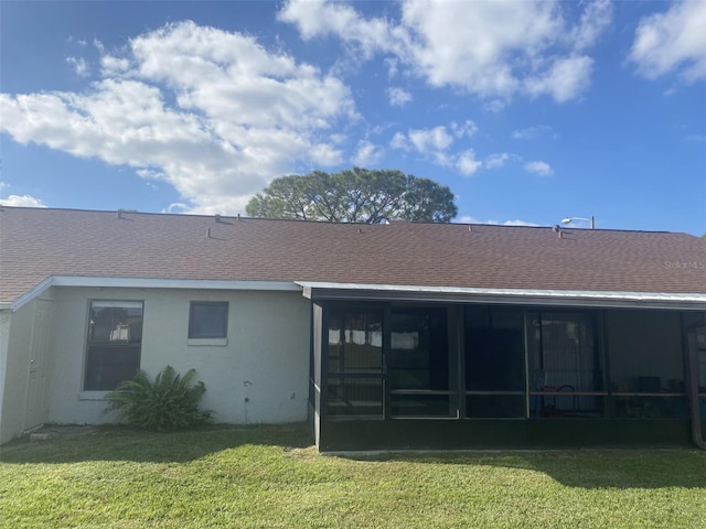 34 Pine Island Cir, Kissimmee, FL 34743 - rear view of house with a shingled roof, a yard, a sunroom, and stucco siding