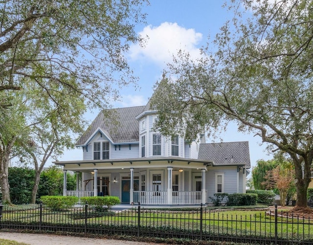 victorian home featuring a front lawn and a porch