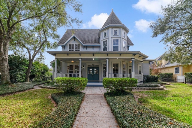 victorian home with covered porch and a front yard