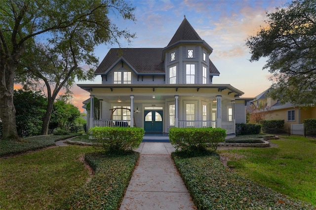 view of front facade with a yard and covered porch