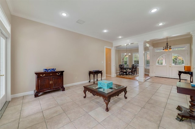 tiled living room with a chandelier, french doors, ornamental molding, and decorative columns