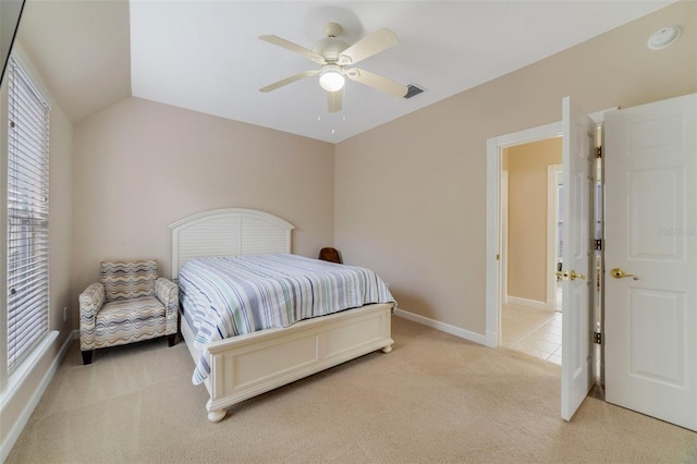 carpeted bedroom with vaulted ceiling and ceiling fan