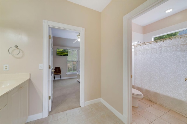 full bathroom featuring vanity, tile patterned floors, ceiling fan, toilet, and shower / bath combo with shower curtain