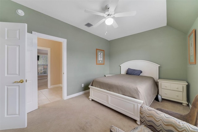 bedroom featuring light colored carpet, vaulted ceiling, and ceiling fan