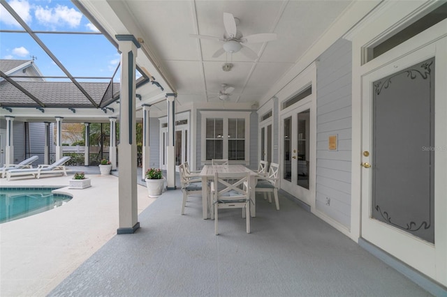 unfurnished sunroom featuring ceiling fan and a swimming pool