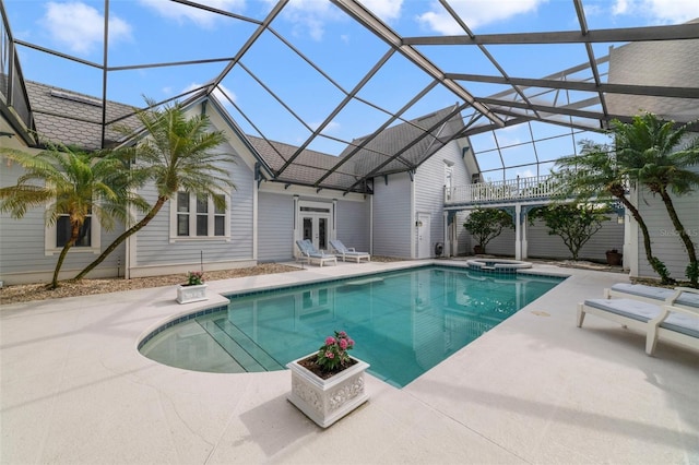 view of pool featuring an in ground hot tub, french doors, a patio, and glass enclosure