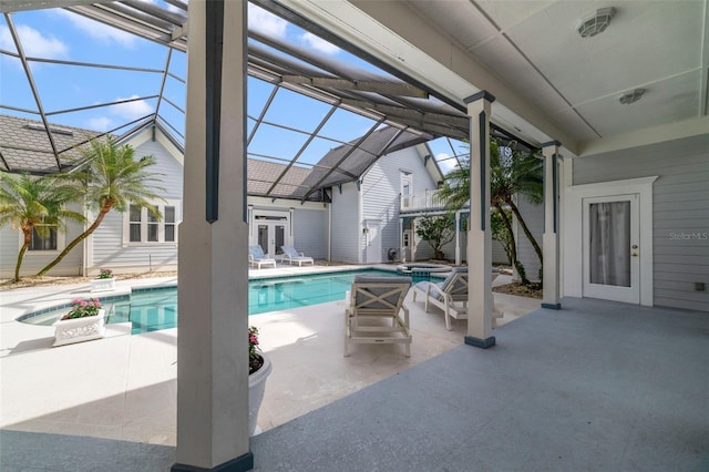 view of swimming pool with glass enclosure, french doors, a patio, and a hot tub