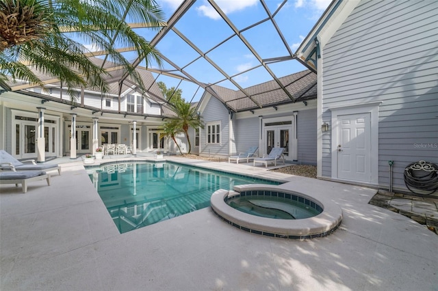 view of swimming pool featuring an in ground hot tub, french doors, a patio, and a lanai