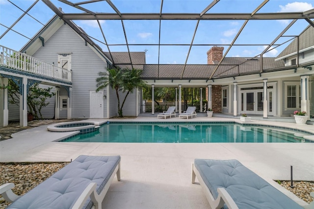 view of pool featuring a patio area, an in ground hot tub, french doors, and glass enclosure