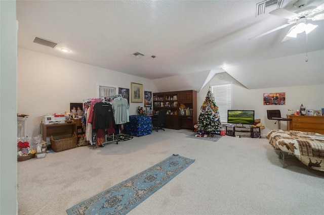 interior space with carpet, ceiling fan, and vaulted ceiling