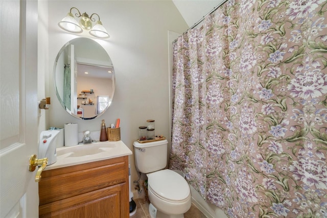 bathroom with toilet, vanity, vaulted ceiling, and tile patterned flooring