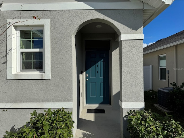 doorway to property featuring central AC unit