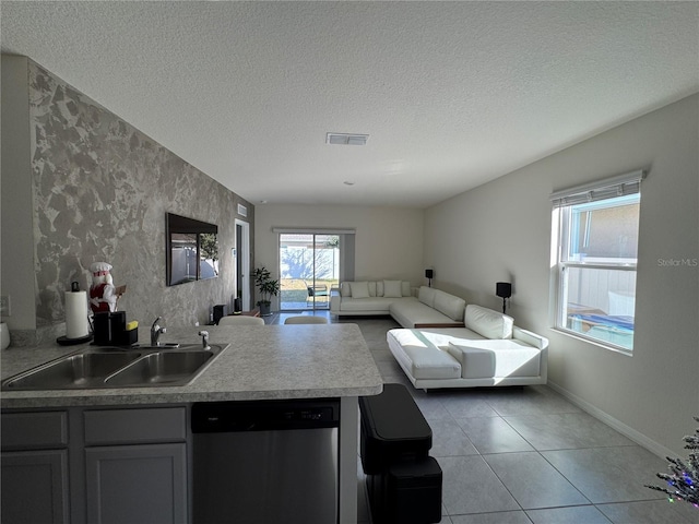 kitchen featuring dishwasher, gray cabinets, plenty of natural light, and sink