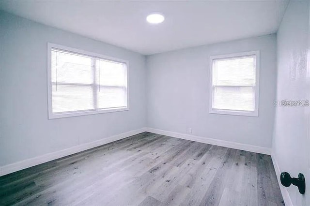 unfurnished room with light hardwood / wood-style floors