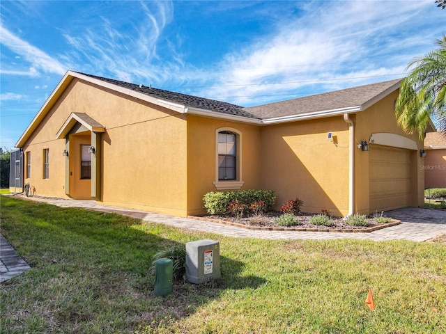 view of property exterior featuring a lawn and a garage