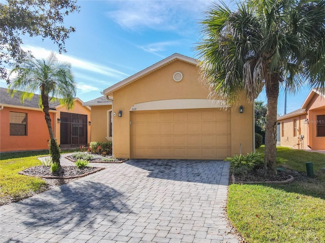 view of front of property featuring a garage and a front lawn