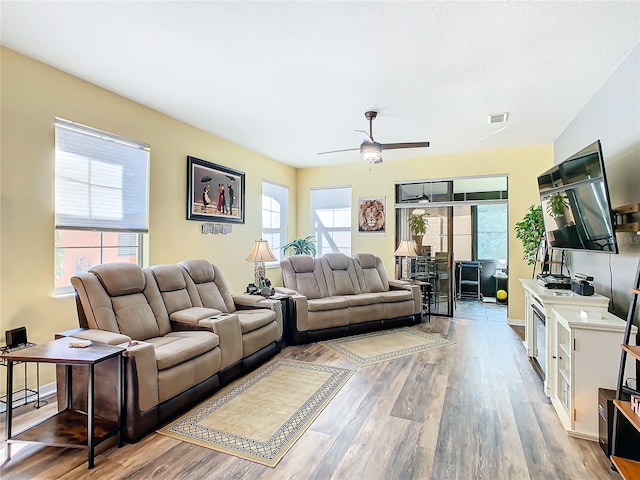 living room with wood-type flooring and ceiling fan