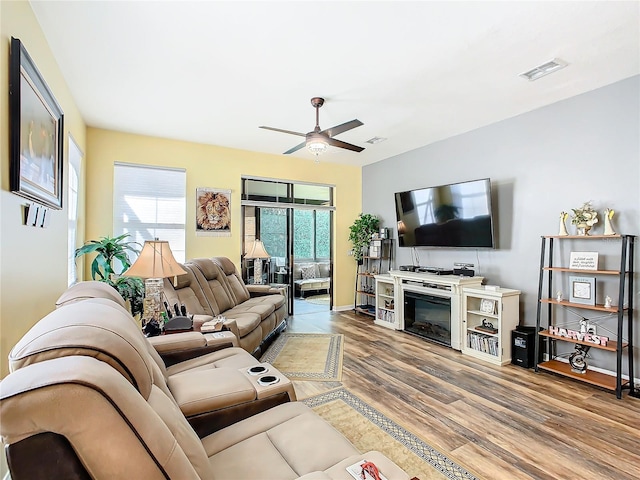 living room with hardwood / wood-style flooring and ceiling fan