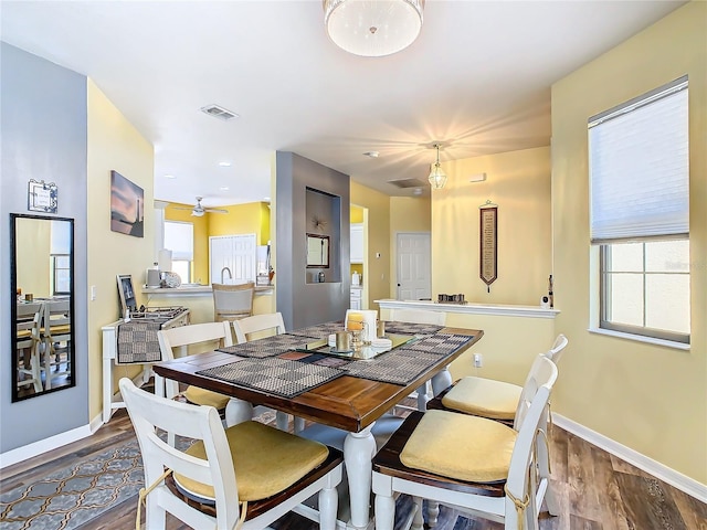 dining area with hardwood / wood-style floors and ceiling fan