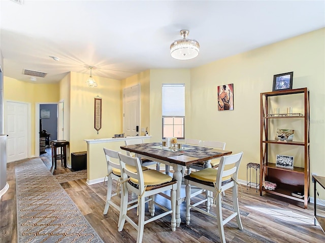 dining room with hardwood / wood-style flooring