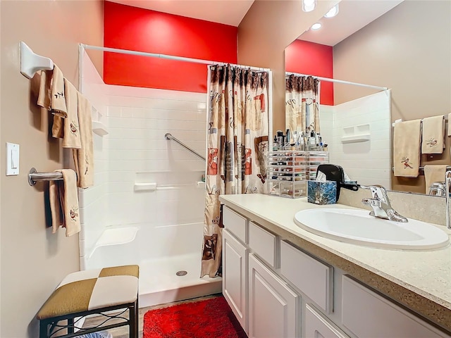 bathroom featuring curtained shower and vanity