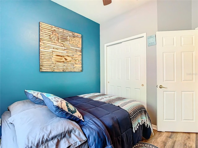 bedroom featuring ceiling fan, a closet, and hardwood / wood-style floors