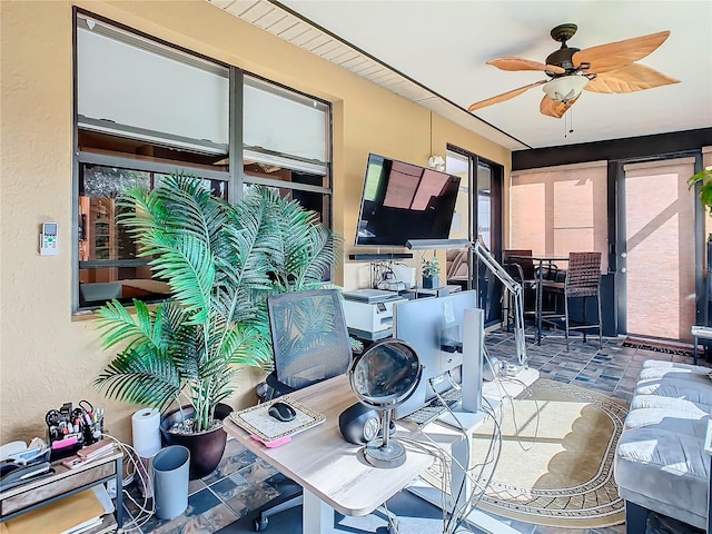 interior space with ceiling fan