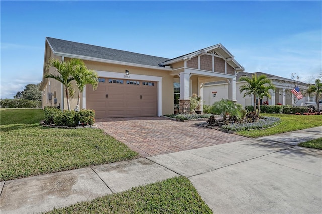 view of front of property with a front yard and a garage