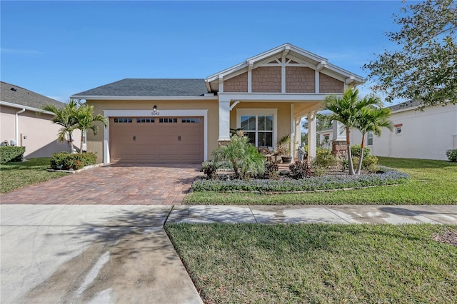 craftsman-style house featuring a front yard and a garage