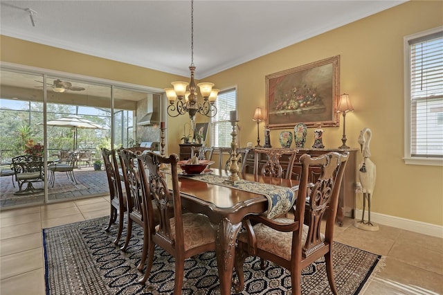 tiled dining room with a chandelier