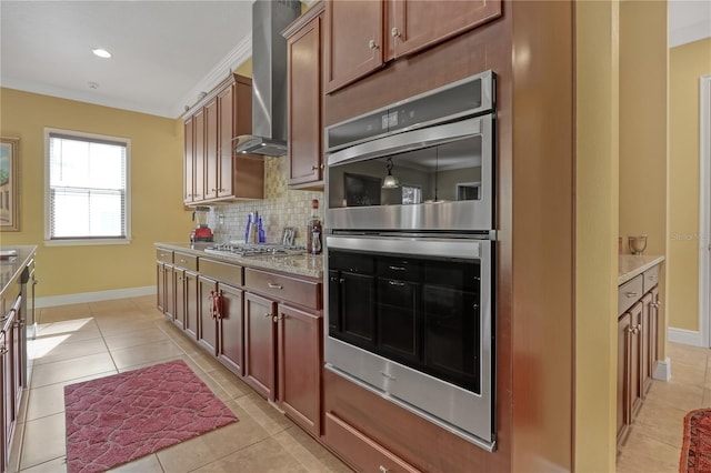 kitchen featuring backsplash, wall chimney exhaust hood, stainless steel appliances, and ornamental molding