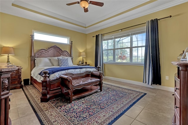 bedroom with a raised ceiling, ceiling fan, light tile patterned floors, and ornamental molding