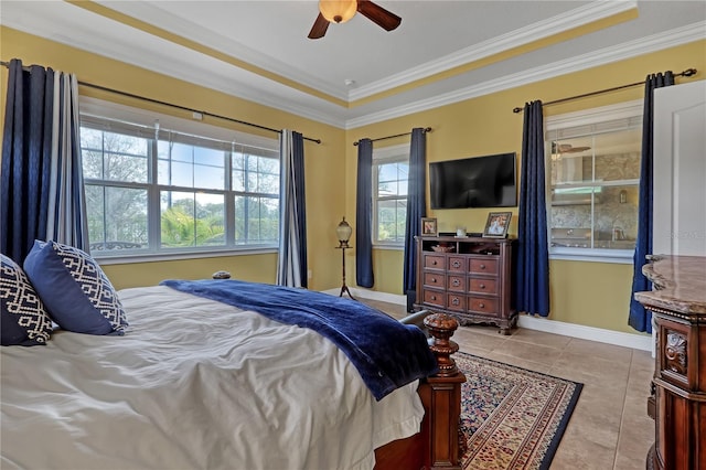 bedroom featuring a tray ceiling, ceiling fan, light tile patterned flooring, and ornamental molding