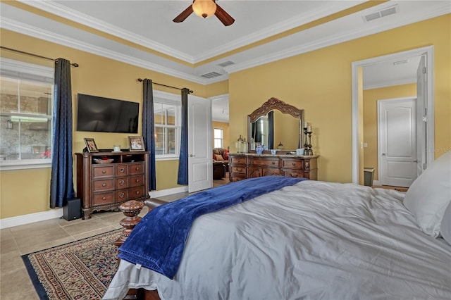 bedroom featuring a raised ceiling, ceiling fan, light tile patterned flooring, and ornamental molding